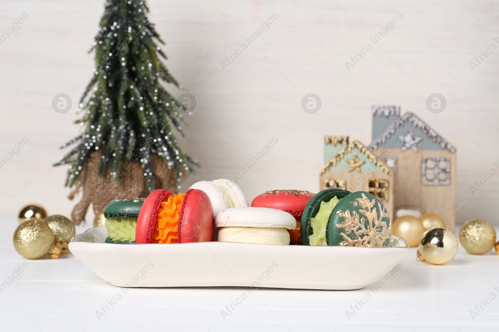 Photo of Beautifully decorated Christmas macarons and festive decor on white table