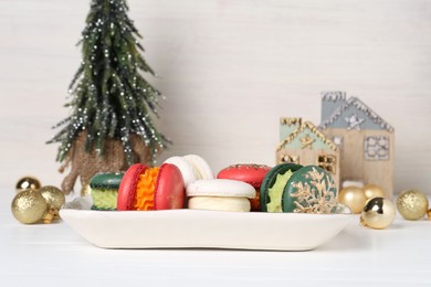 Photo of Beautifully decorated Christmas macarons and festive decor on white table
