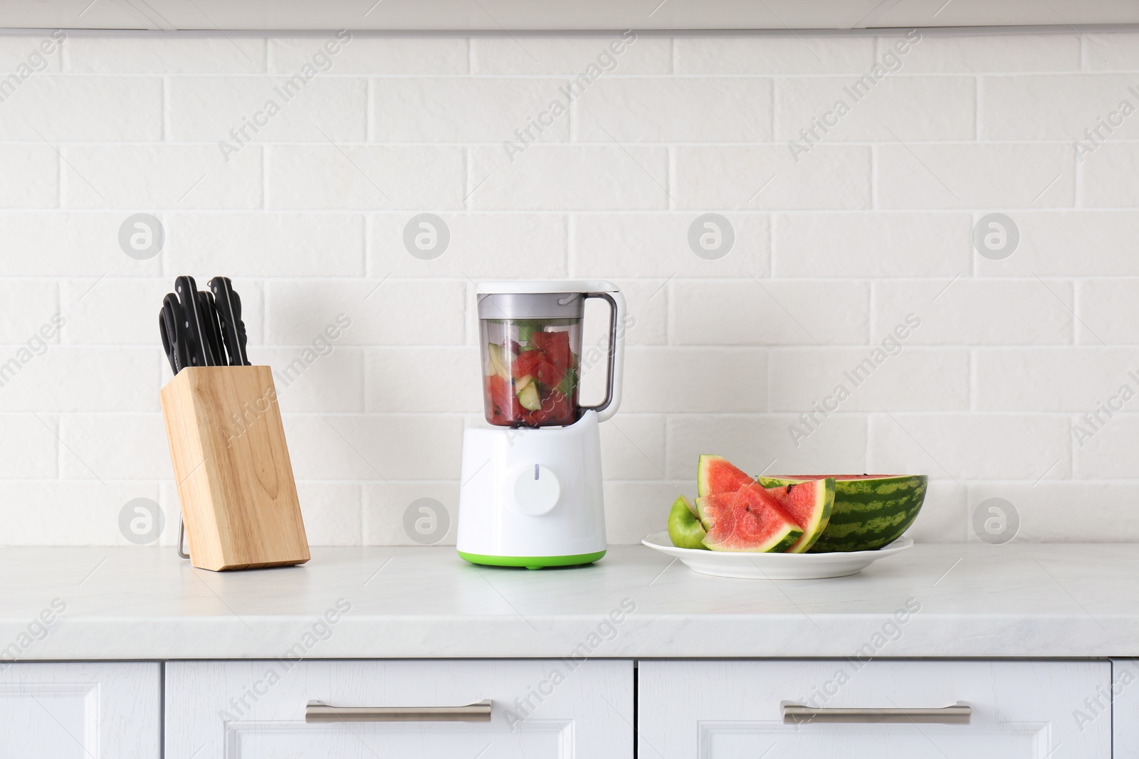 Photo of Blender and smoothie ingredients on counter in kitchen