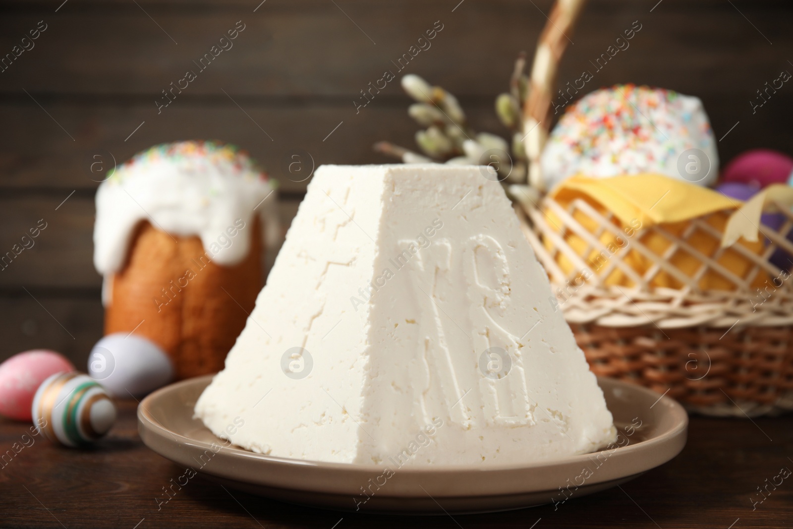 Photo of Traditional cottage cheese Easter paskha on wooden table, closeup