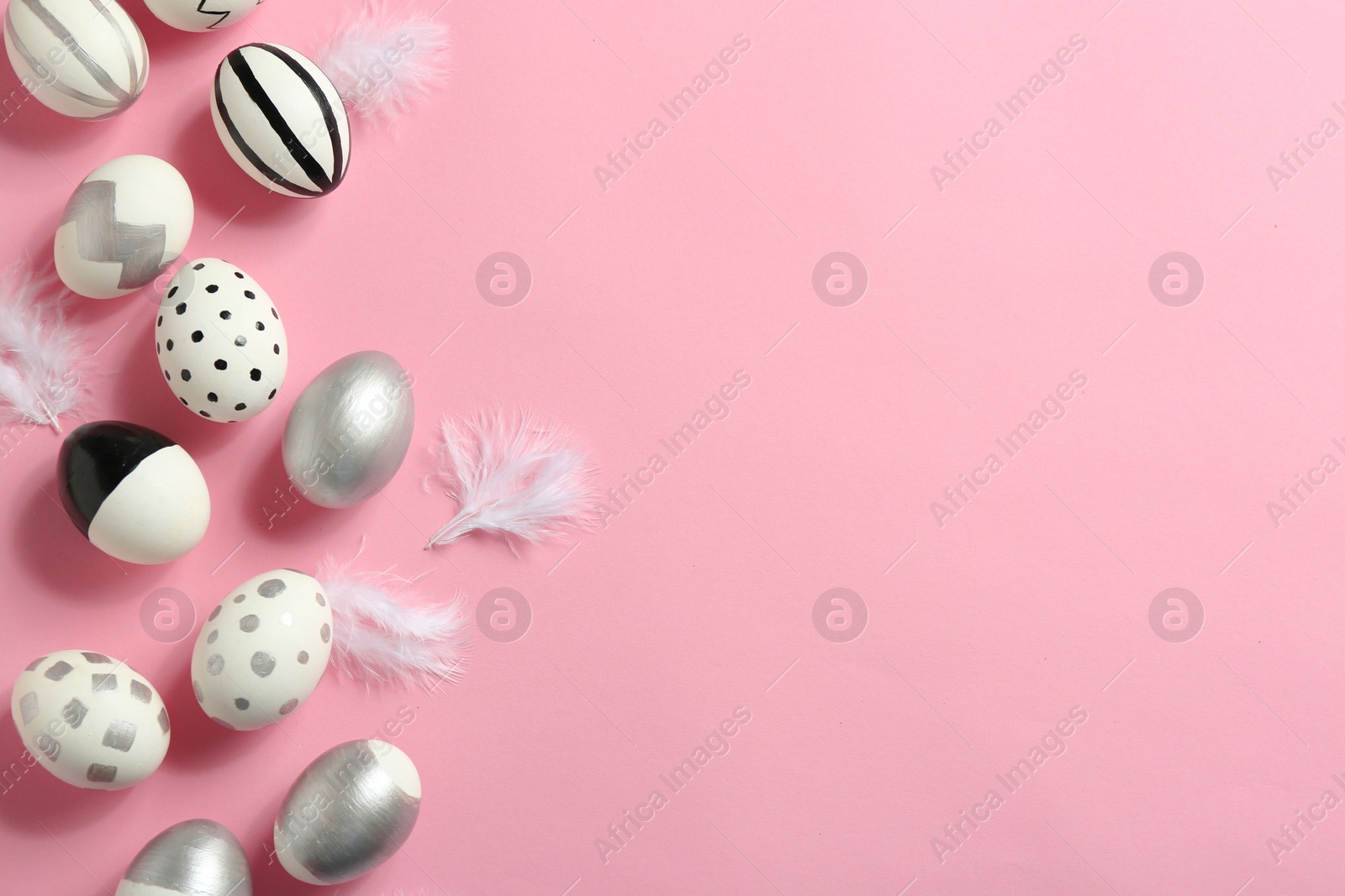 Photo of Painted Easter eggs on color background, flat lay with space for text