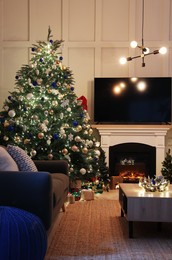 Photo of Cozy living room interior with beautiful Christmas tree near fireplace