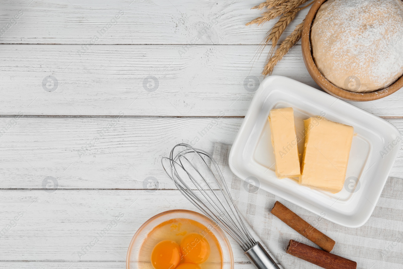 Photo of Flat lay composition with eggs and other ingredients  on white wooden table, space for text. Baking pie