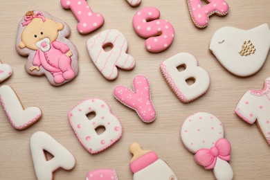 Set of baby shower cookies on wooden table, flat lay