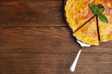 Delicious pie with minced meat on wooden table, top view. Space for text