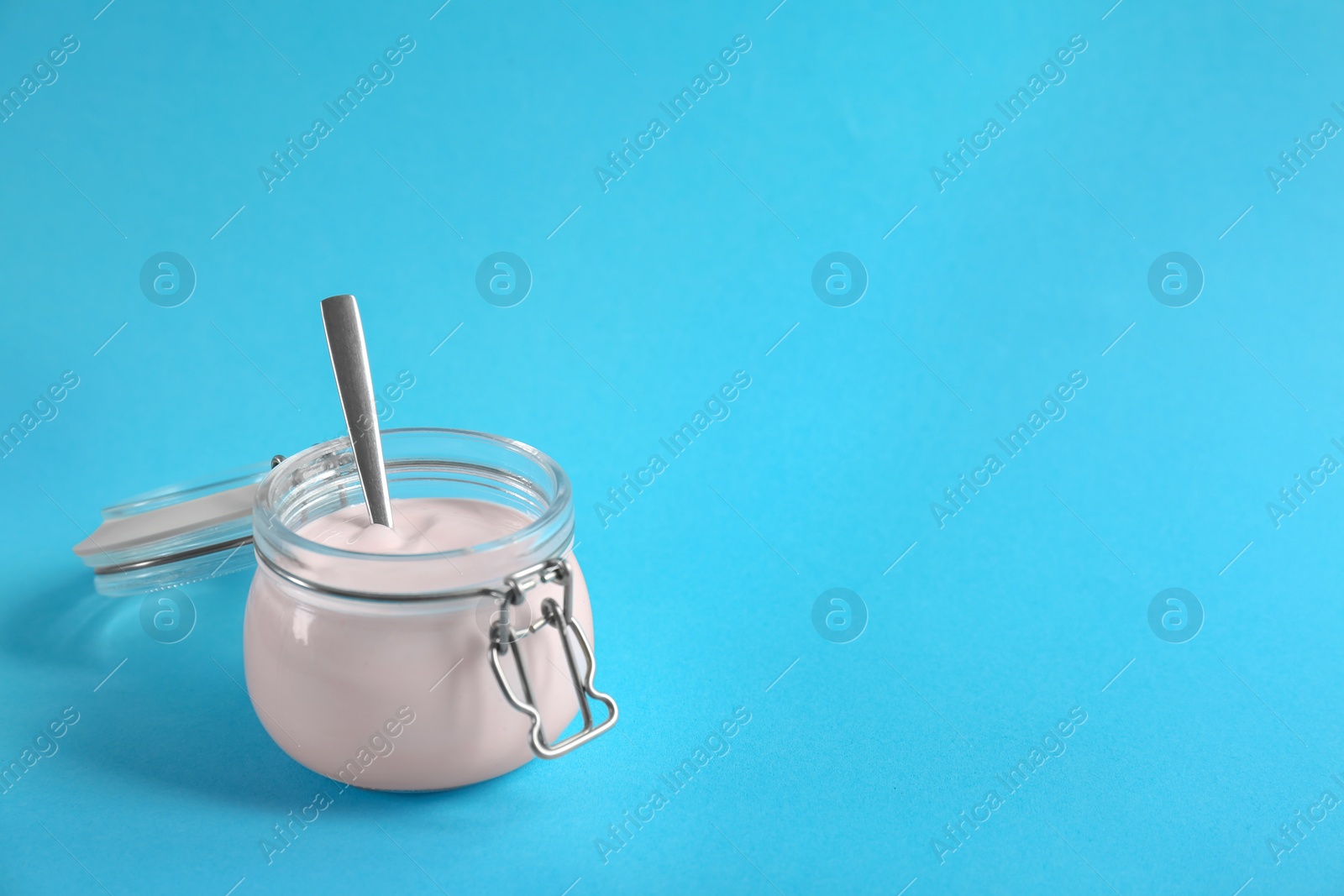 Photo of Jar with tasty yogurt on color background