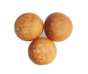 Photo of Fresh tasty buns with sesame seeds isolated on white, top view