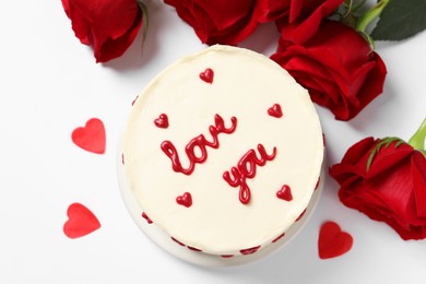 Photo of Bento cake with text Love You, paper hearts and roses on white table, flat lay. St. Valentine's day surprise