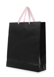 Photo of Paper shopping bag with handles on white background. Mockup for design