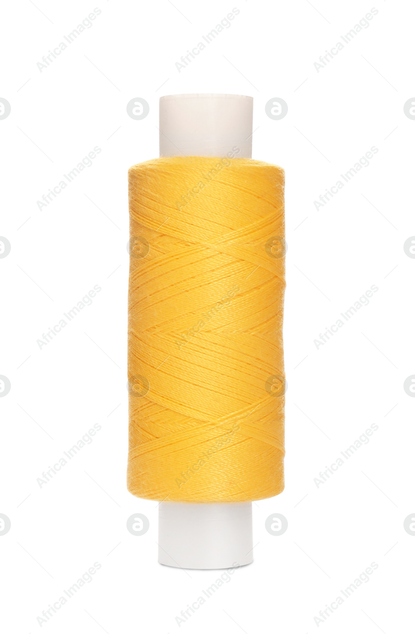 Photo of Spool of yellow sewing thread isolated on white