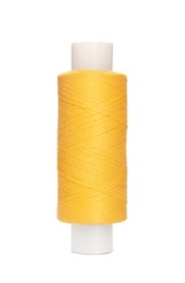 Photo of Spool of yellow sewing thread isolated on white