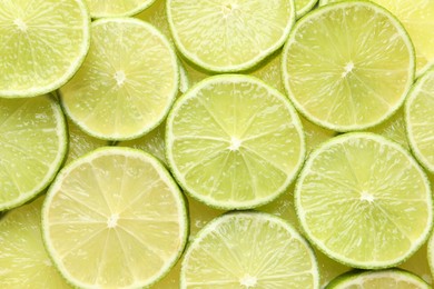 Photo of Fresh juicy lime slices as background, top view