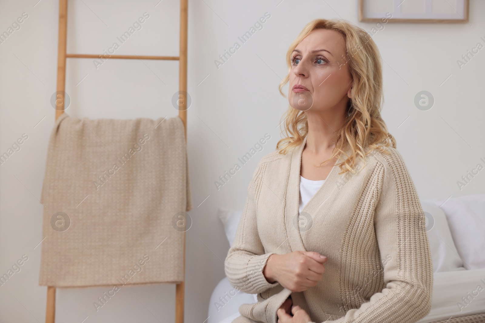 Photo of Upset middle aged woman at home, space for text. Loneliness concept