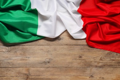 Flag of Italy on wooden background, top view. Space for text