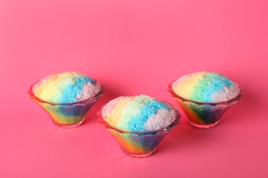 Photo of Rainbow shaving ice in glass dessert bowls on pink background