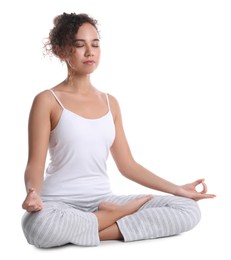 Beautiful African-American woman meditating on white background