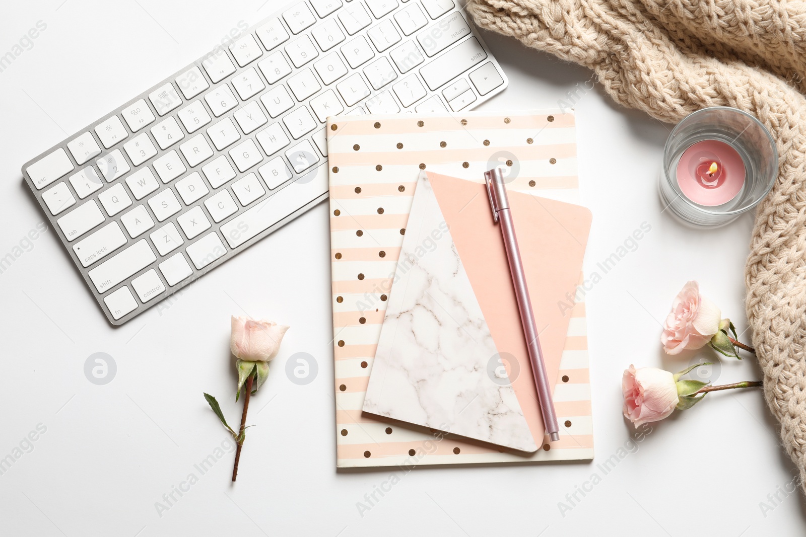 Photo of Flat lay composition with notebooks, warm blanket and computer keyboard on white background