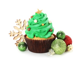 Photo of Tasty Christmas tree cupcake and festive decor on white background