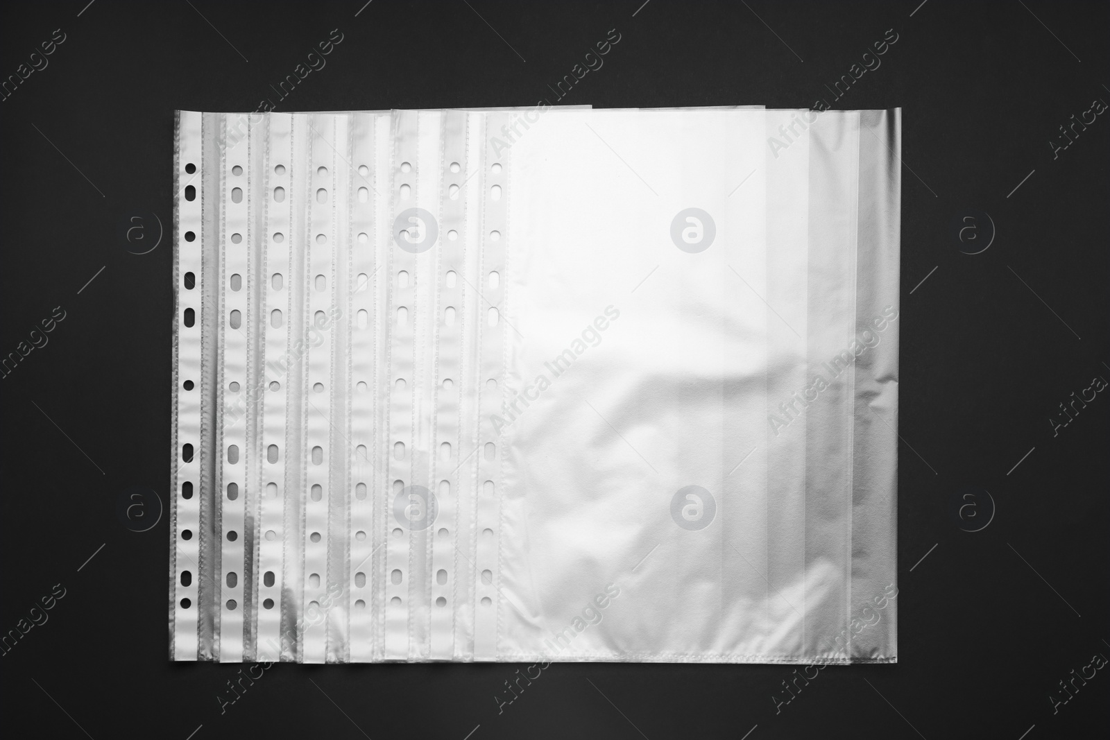 Photo of Punched pockets on black background, flat lay