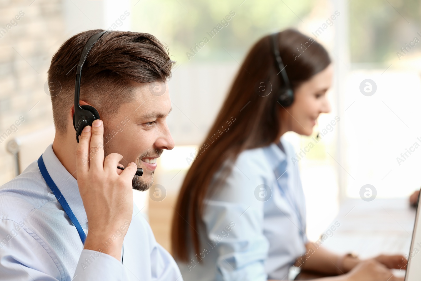 Photo of Technical support operators with headsets at workplace