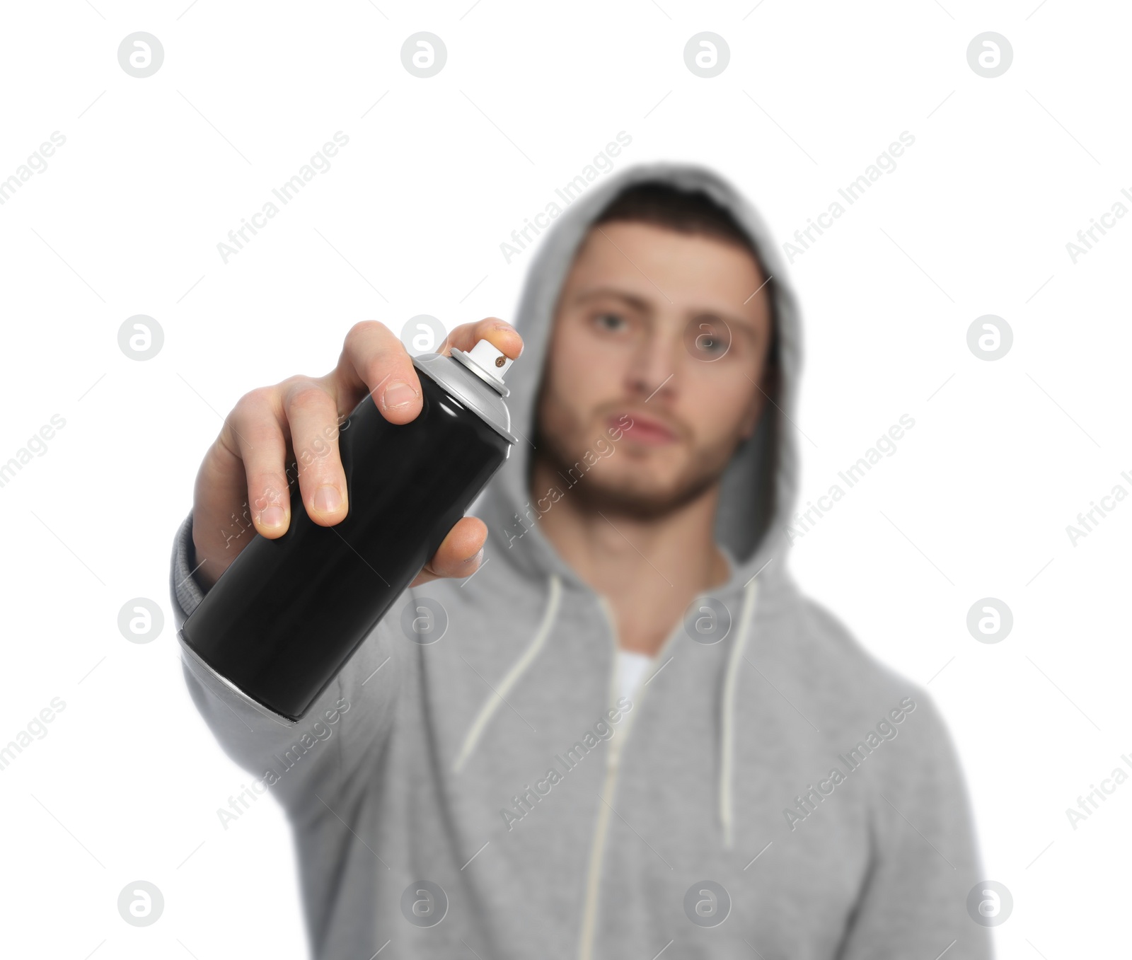 Photo of Handsome man holding can of black spray paint against white background