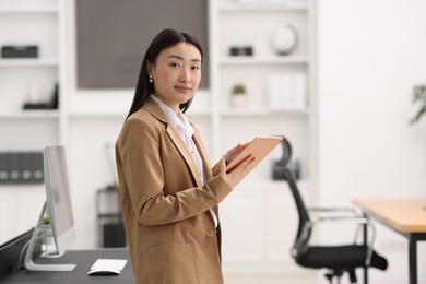 Photo of Portrait of beautiful businesswoman with tablet in office