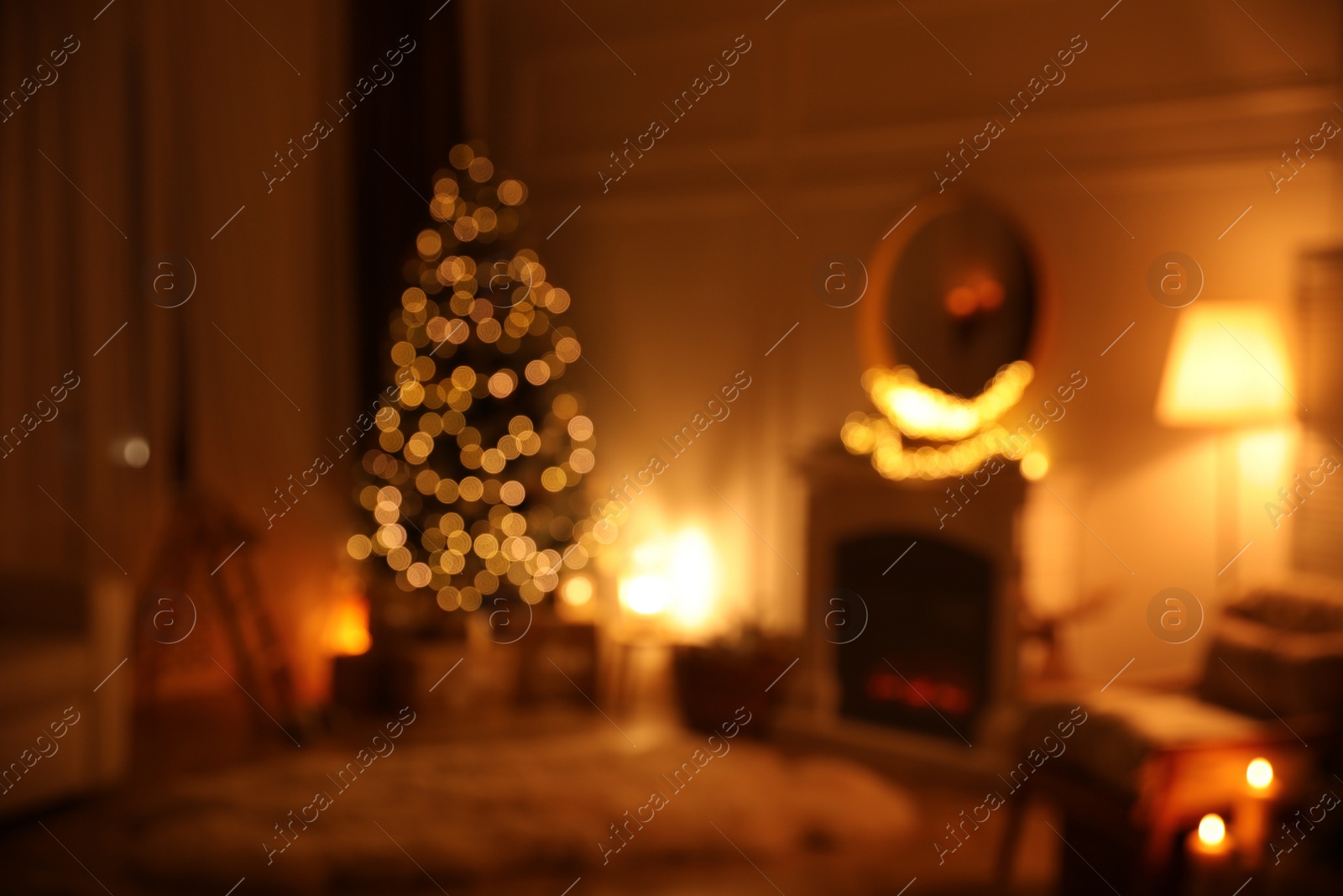 Photo of Blurred view of beautiful room interior with Christmas tree and fireplace