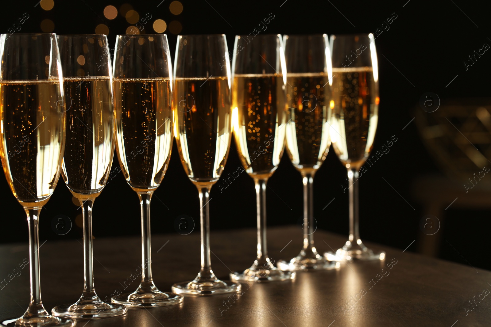 Photo of Many glasses of champagne on table. Space for text