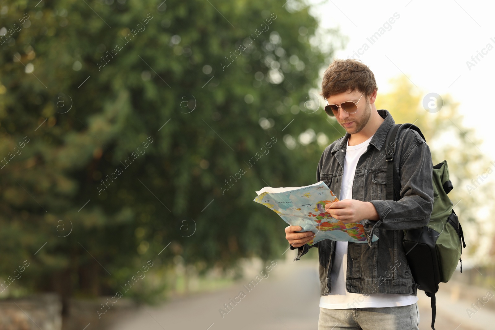 Photo of Traveler with world map on city street