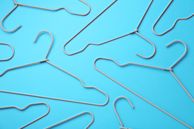 Photo of Hangers on light blue background, flat lay