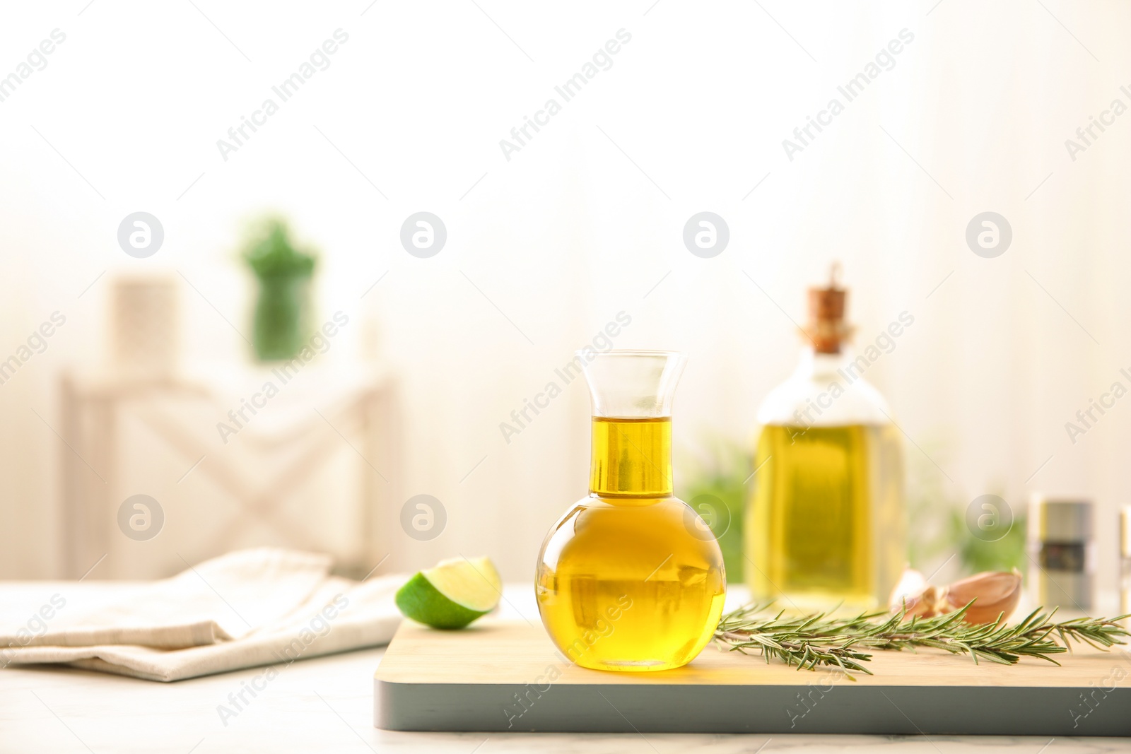 Photo of Composition with fresh rosemary oil on table