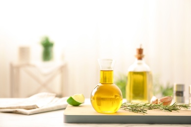 Photo of Composition with fresh rosemary oil on table