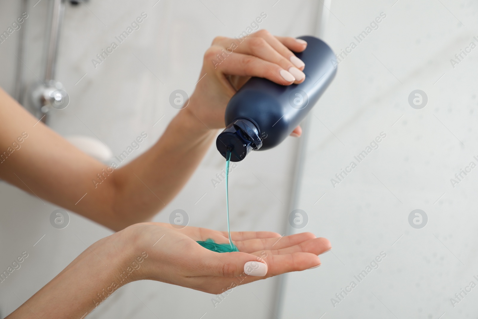 Photo of Young woman using gel in shower at home, closeup