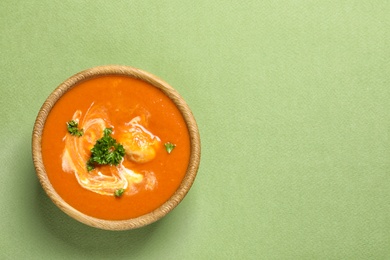 Bowl of delicious butter chicken on color background, top view with space for text. Traditional indian Murgh Makhani
