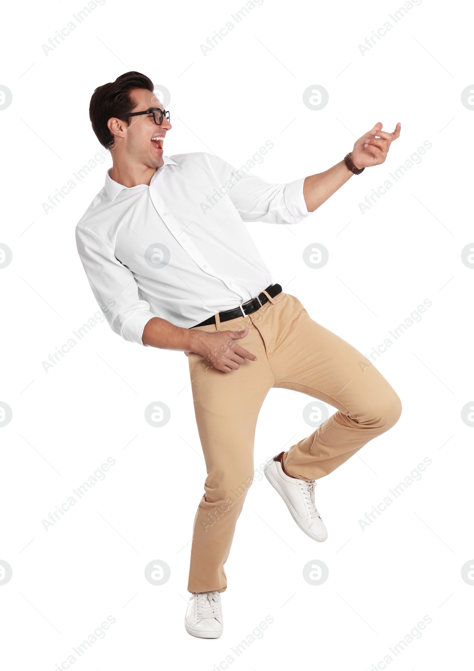 Photo of Handsome young man with glasses dancing on white background