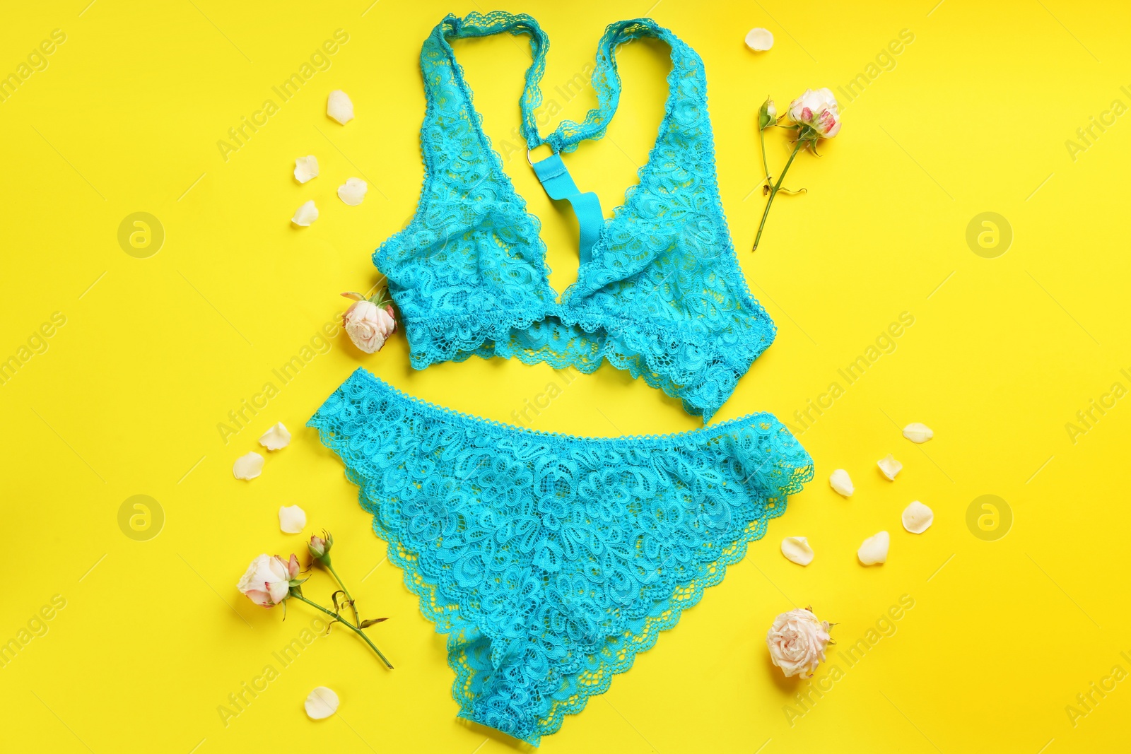 Photo of Flat lay composition with sexy women's underwear on yellow background