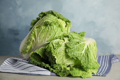 Fresh ripe Chinese cabbages on grey table