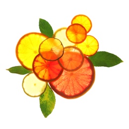 Illuminated slices of citrus fruits and leaves on white background, top view