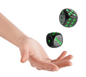 Man throwing black dice on white background, closeup