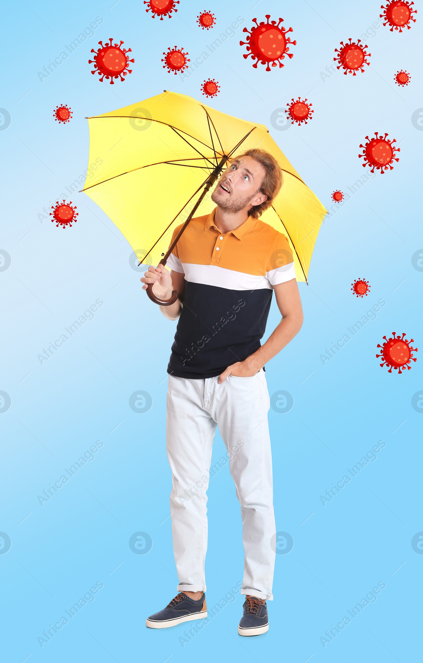 Image of Man protecting himself from viruses with yellow umbrella as symbol of strong immunity