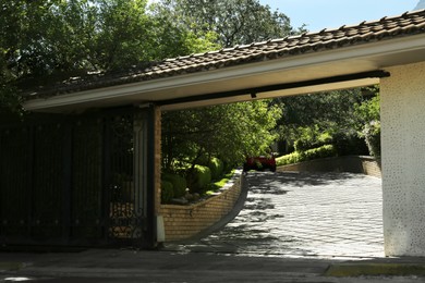 Photo of Opened security metal gates near trees outdoors