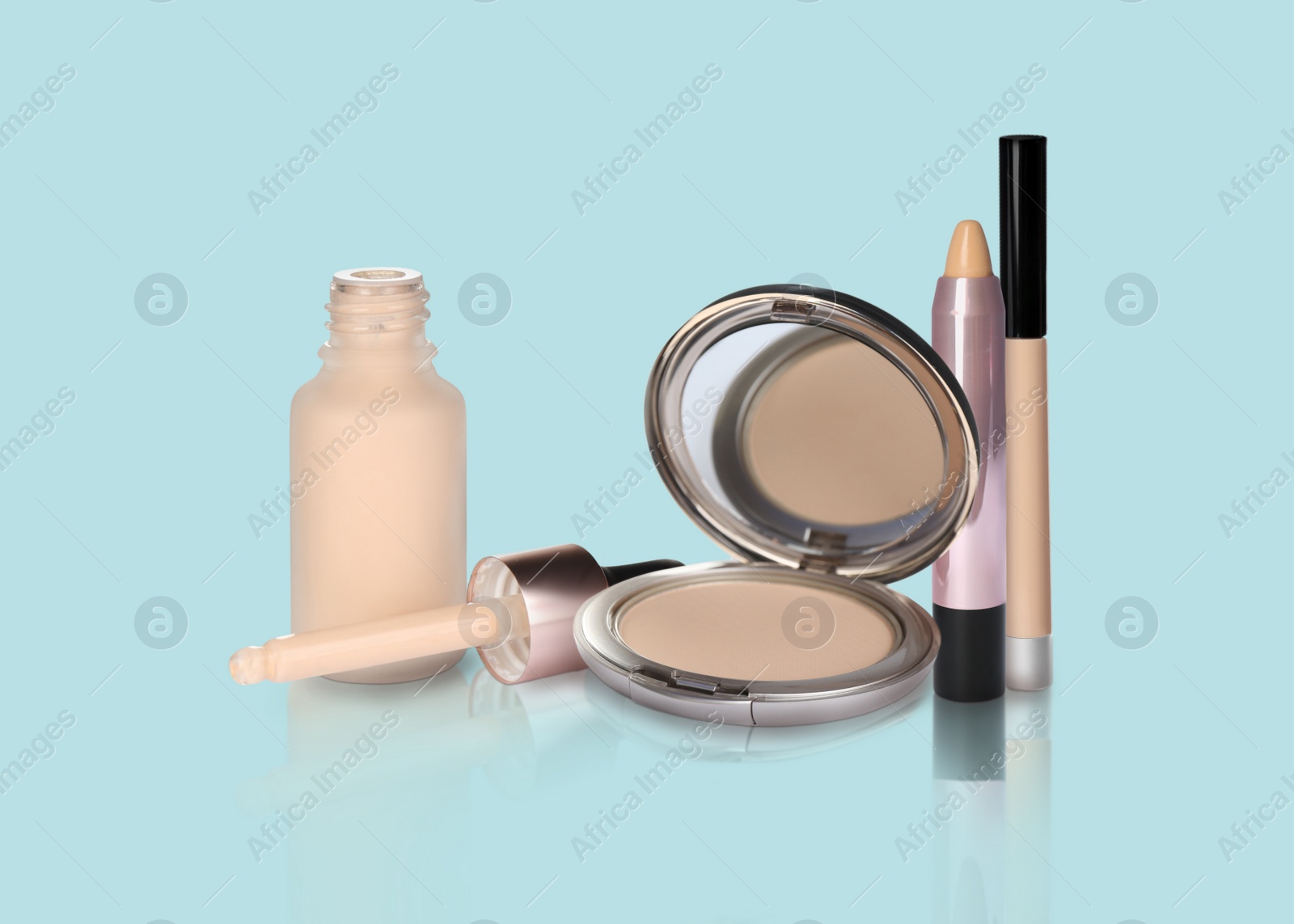 Image of Set with different decorative cosmetics on light blue background. Luxurious makeup products