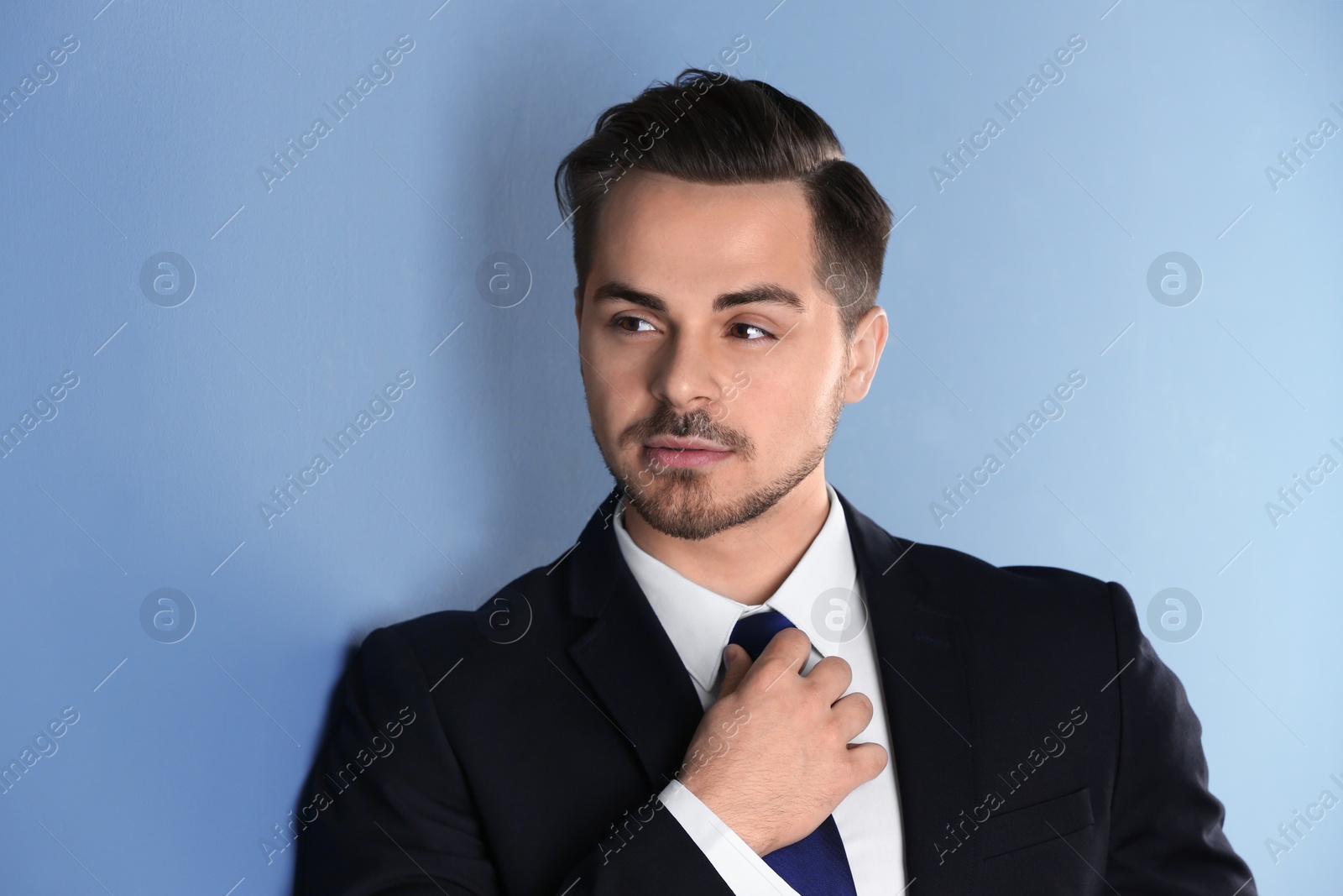 Photo of Portrait of young man with beautiful hair on color background