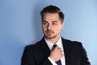 Portrait of young man with beautiful hair on color background