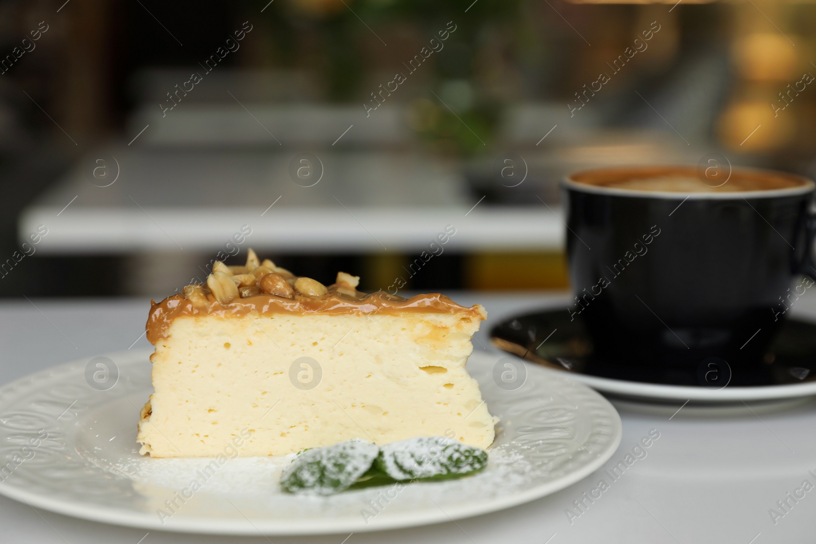 Photo of Tasty dessert and cup of fresh coffee on table in cafeteria