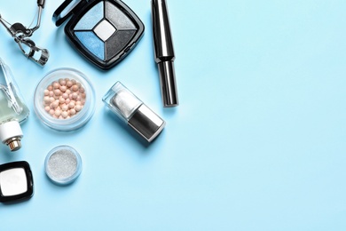 Photo of Decorative cosmetics and tools of professional makeup artist on color background