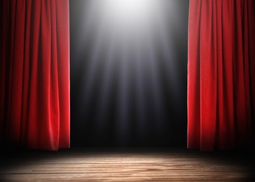 Image of Empty wooden stage and open red curtains