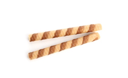 Delicious wafer rolls on white background, top view. Sweet food