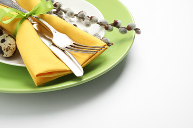 Photo of Festive Easter table setting with floral decor on white background, closeup