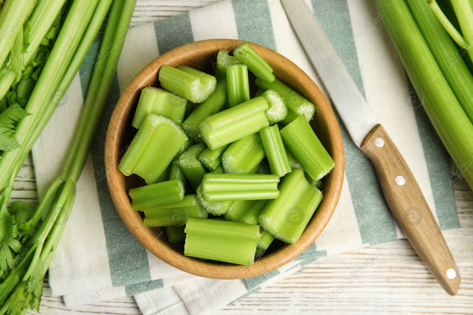 Photo of Fresh ripe green celery on white wooden table, flat lay